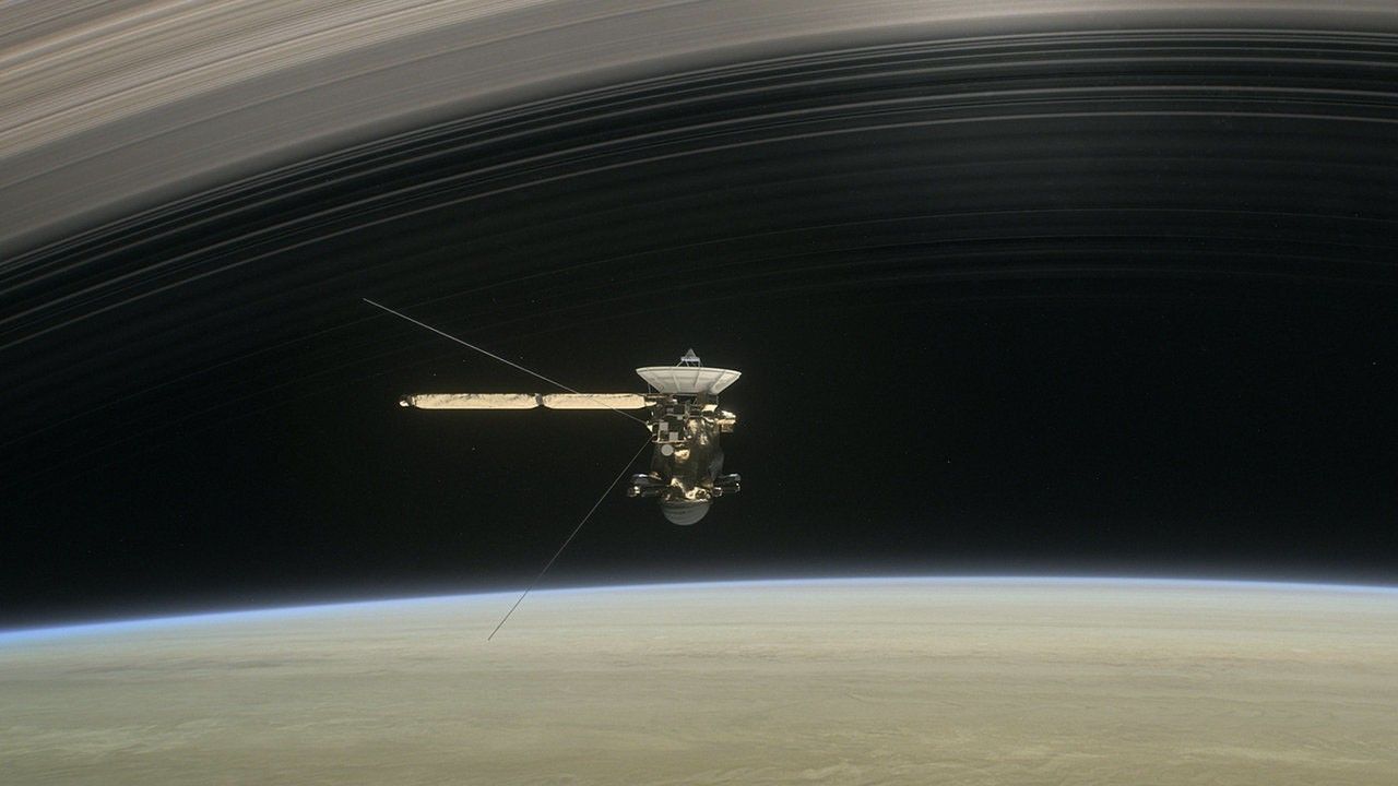 An illustration of Cassini diving between Saturn and its innermost ring.